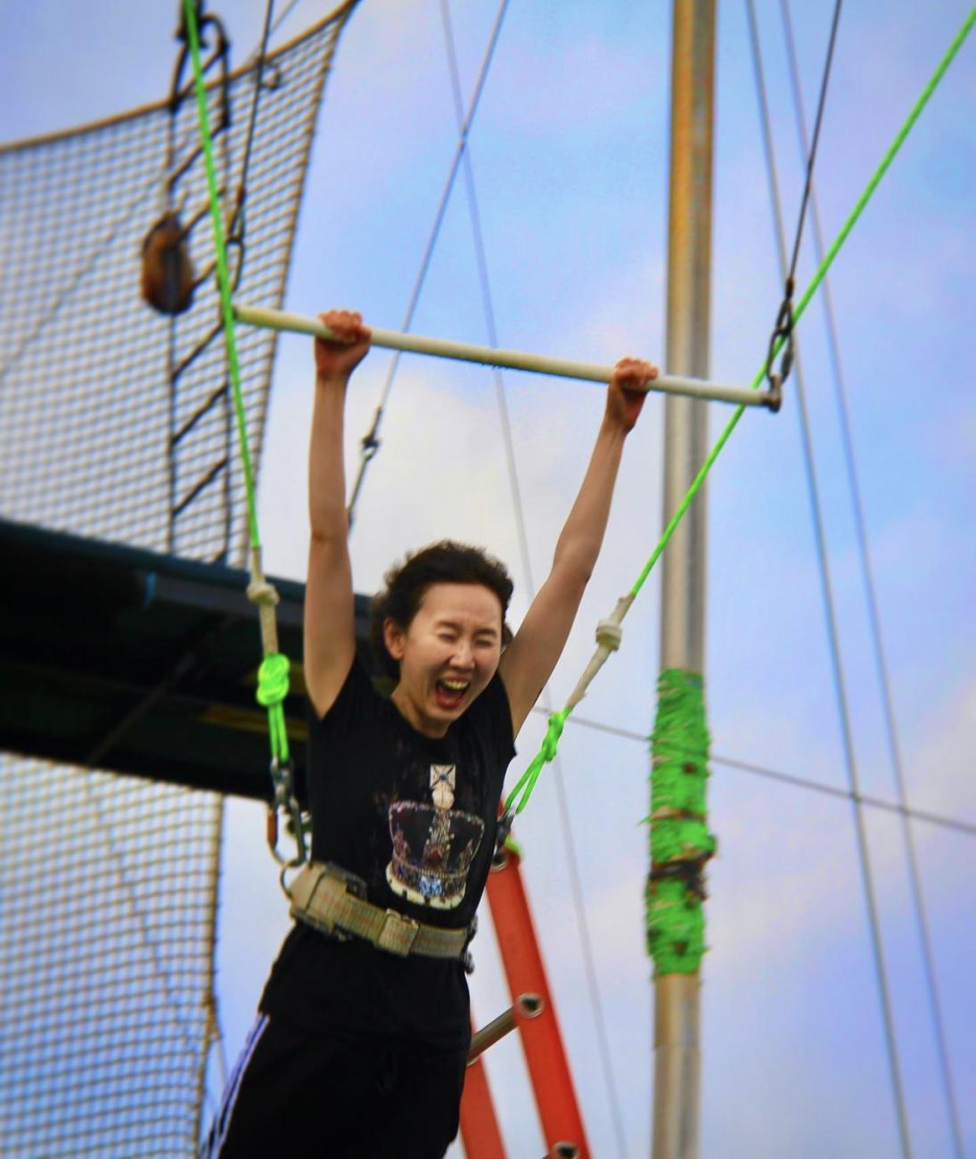 Davis Polk summer associate trying out a trapeze bar