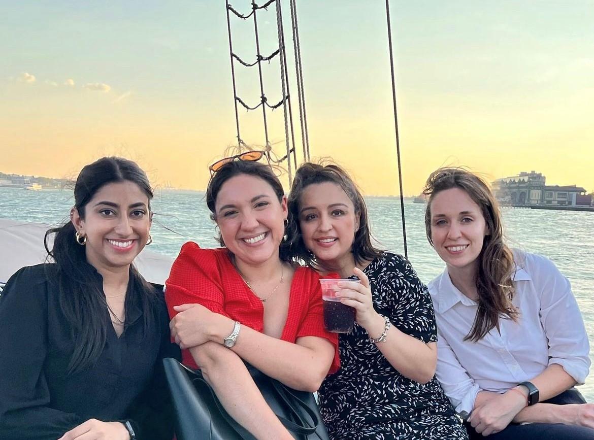 Four Davis Polk summer associates on a boat tour of New York harbor